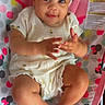 baby, infant, child, headband, bow, sitting, clothing, polka_dots, hearts, baby_seat, colorful, cute, smiling, hands, legs, feet, indoors, portrait, playful, happy