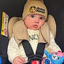 baby, child, car_seat, hat, mickey_mouse, plush_toy, toy, seatbelt, clothing, infant, cute, indoors, person, face, hand, sitting, warm, soft_toy, headwear, safety