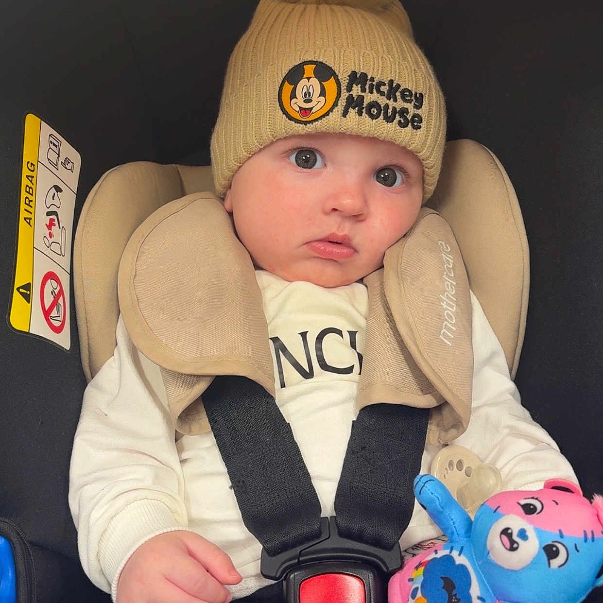 Vaelen joined the competition — help win amazing prizes! baby, car_seat, child, clothing, cute, face, hand, hat, headwear, indoors, infant, mickey_mouse, person, plush_toy, safety, seatbelt, sitting, soft_toy, toy, warm