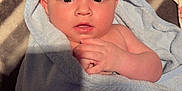 Vaelen is registered to the contest to win money with this photo: baby, blanket, blue, child, clothing, curious, cute, face, hands, hood, indoors, infant, lying, newborn, portrait, skin, soft, striped, towel, wrapped