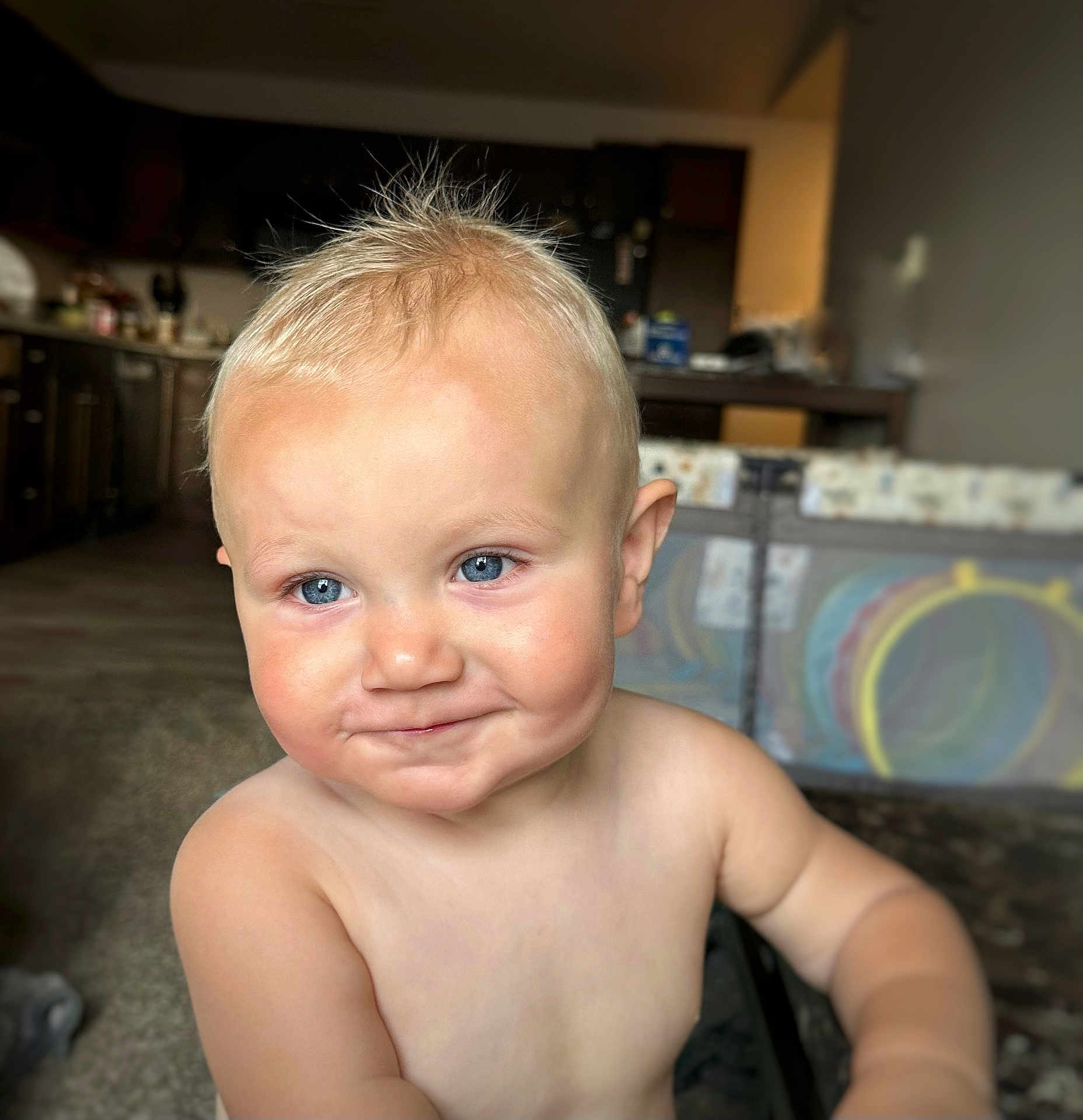 Harlen is registered to the contest to win money with this photo: toddler, child, blonde_hair, blue_eyes, smiling, shirtless, indoor, kitchen, playpen, baby, face, person, cute, young_child, home, portrait, happy, skin, expression, blurry_background