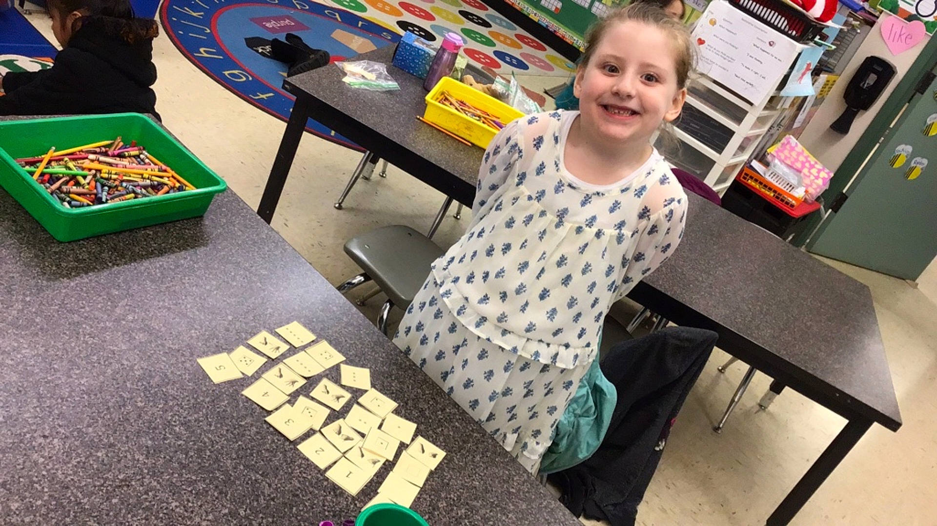 Leeann Marie joined the competition — help win amazing prizes! chair, child, flooring, fun, furniture, games, indoor_games_and_sports, joy, learning, leisure, pattern, person, play, reading, recreation, retail, room, sitting, smile, t_shirt