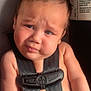 baby, car_seat, child, straps, seatbelt, infant, face, expression, skin, light, shoulder, arm, hair, sitting, indoors, warning_label, closeup, portrait, safety, cute