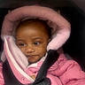 baby, child, infant, pink_jacket, hood, car_seat, safety_harness, warm_clothing, cute, face, portrait, bundle, winter_wear, seatbelt, young_child, looking_away, soft_texture, closeup, indoor, small_person