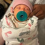 Neveah is registered to the contest to win money with this photo: baby, blanket, cozy, cradling, footprints, hand, hat, indoor, infant, newborn, pacifier, peaceful, person, pink, portrait, sleeping, soft, teal, tender, wrapped