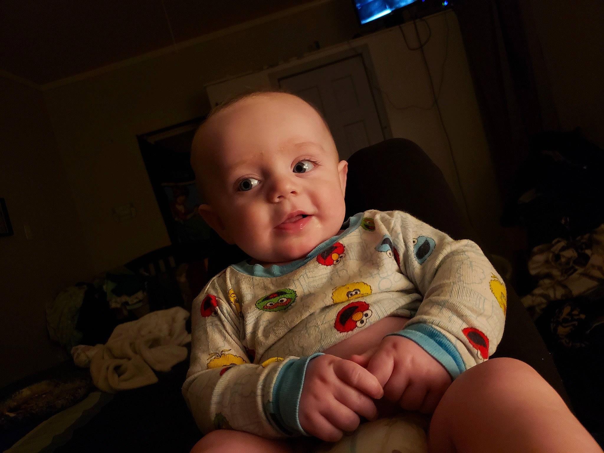 Leeham is registered to the contest to win money with this photo: baby, baby_toddler_clothing, cheek, child, comfort, finger, fun, houseplant, iris, lip, mouth, nose, person, room, sitting, skin, sleeve, t_shirt, thigh, thumb