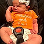 baby, newborn, sleeping, orange_onesie, white_bow, headband, car_seat, straps, buckle, infant, cute, peaceful, legs, feet, hand, clothing, child, portrait, indoors, resting
