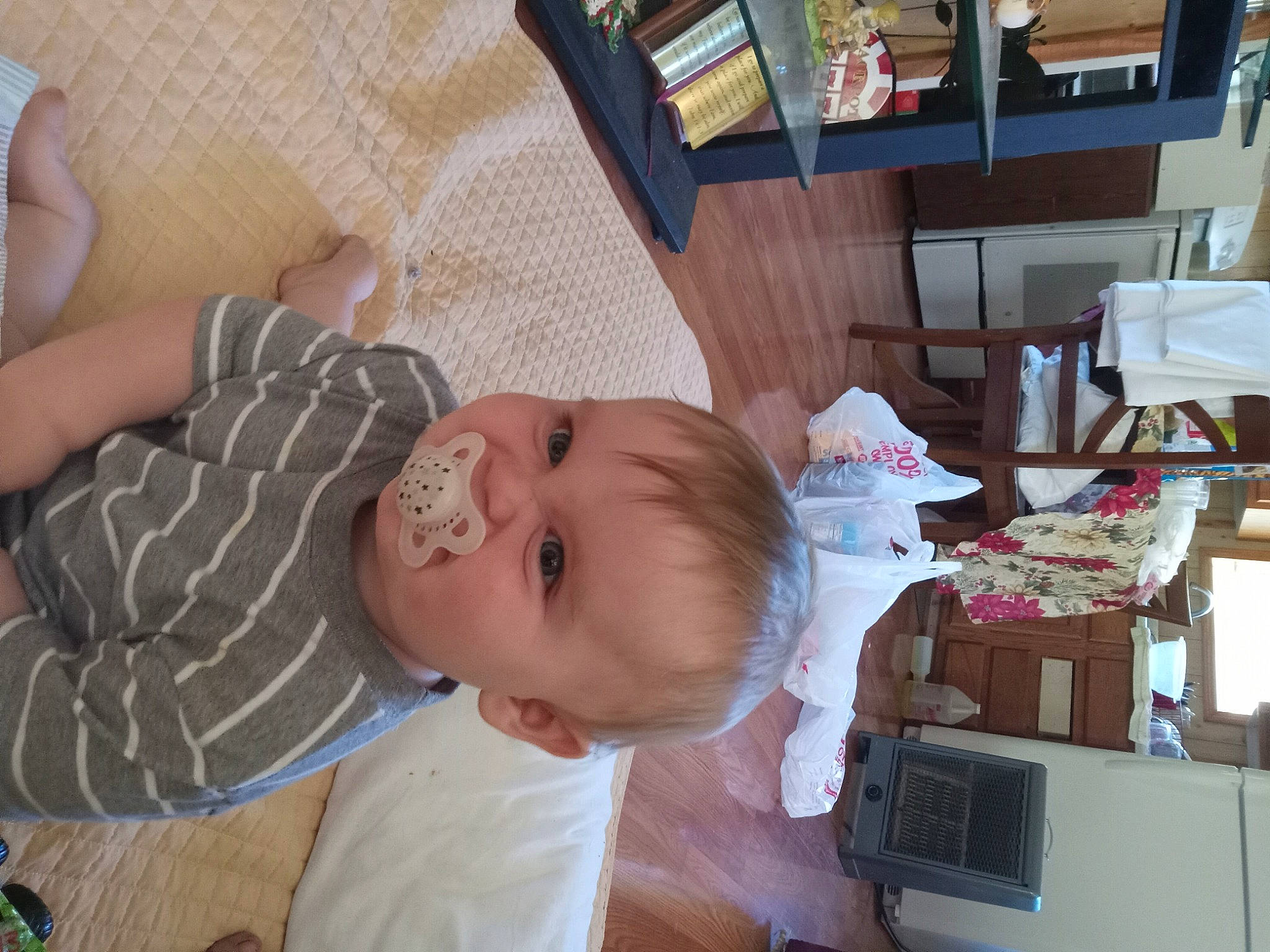 Lucian is registered to the contest to win money with this photo: baby, baby_products, baby_safety, baby_toddler_clothing, chair, cheek, child, flooring, fun, happy, person, play, room, shelf, sitting, skin, smile, table, toddler, vacation