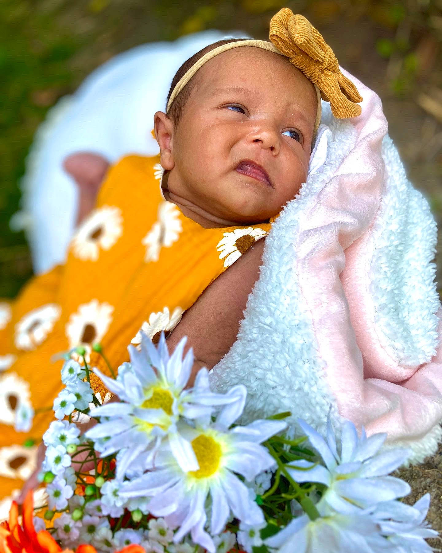 Everleigh is registered to the contest to win money with this photo: baby, baby_toddler_clothing, botany, cap, face, flower, flowering_plant, grass, hand, happy, headgear, iris, people_in_nature, person, petal, photograph, plant, skin, toddler, white