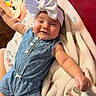 baby, infant, child, smiling, portrait, indoor, lying_down, bow_headband, blue_outfit, polka_dots, denim, blanket, soft_blanket, couch, red_background, toy, colorful, cozy, happy, face
