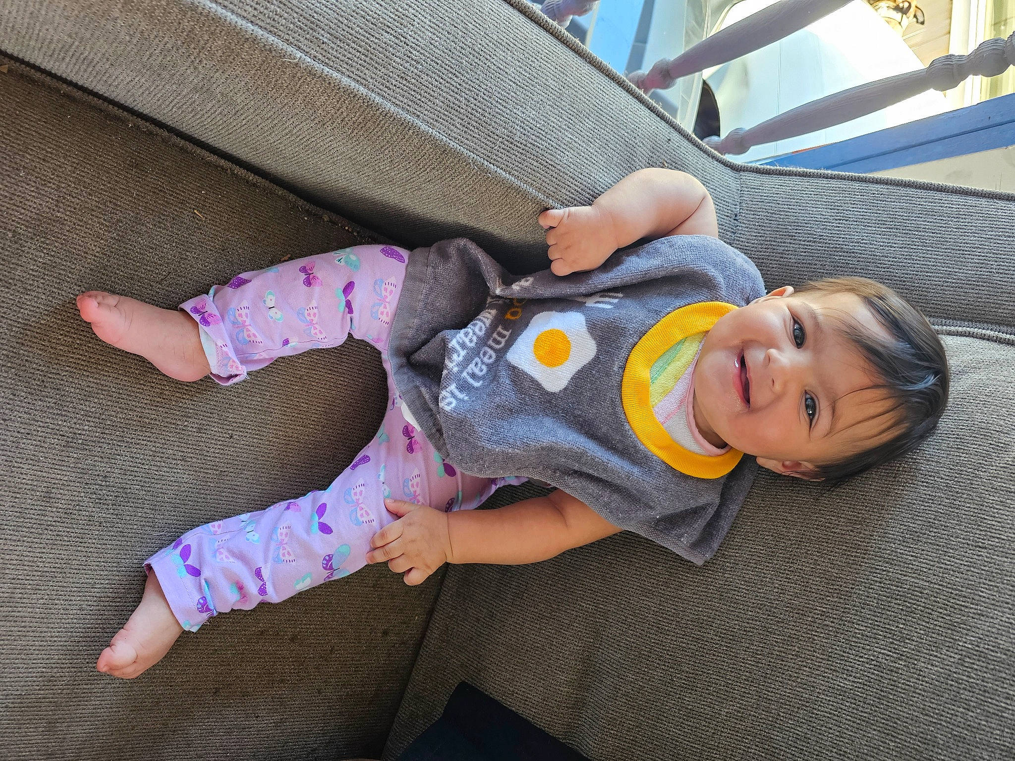 Layliana is registered to the contest to win money with this photo: baby, baby_products, baby_toddler_clothing, child, comfort, couch, floor, flooring, fun, joy, leisure, linens, nap, person, room, sitting, smile, sock, textile, toddler