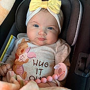 Ehlani joined the competition — help win amazing prizes! baby, child, infant, car_seat, yellow_bow, headband, blanket, pacifier, pink, clothing, winnie_the_pooh, piglet, hug_it_out, cute, portrait, indoors, seat, smiling, face, person