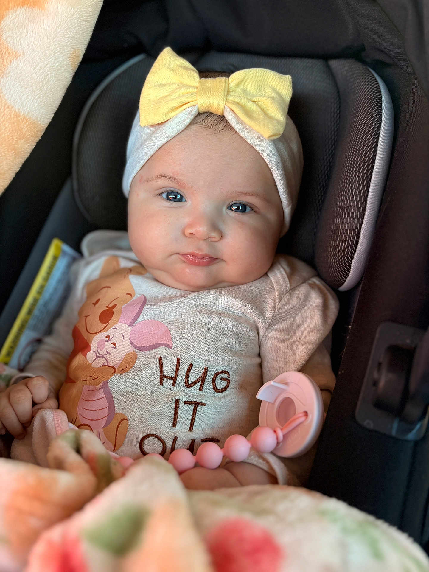 Ehlani joined the competition — help win amazing prizes! baby, child, infant, car_seat, yellow_bow, headband, blanket, pacifier, pink, clothing, winnie_the_pooh, piglet, hug_it_out, cute, portrait, indoors, seat, smiling, face, person