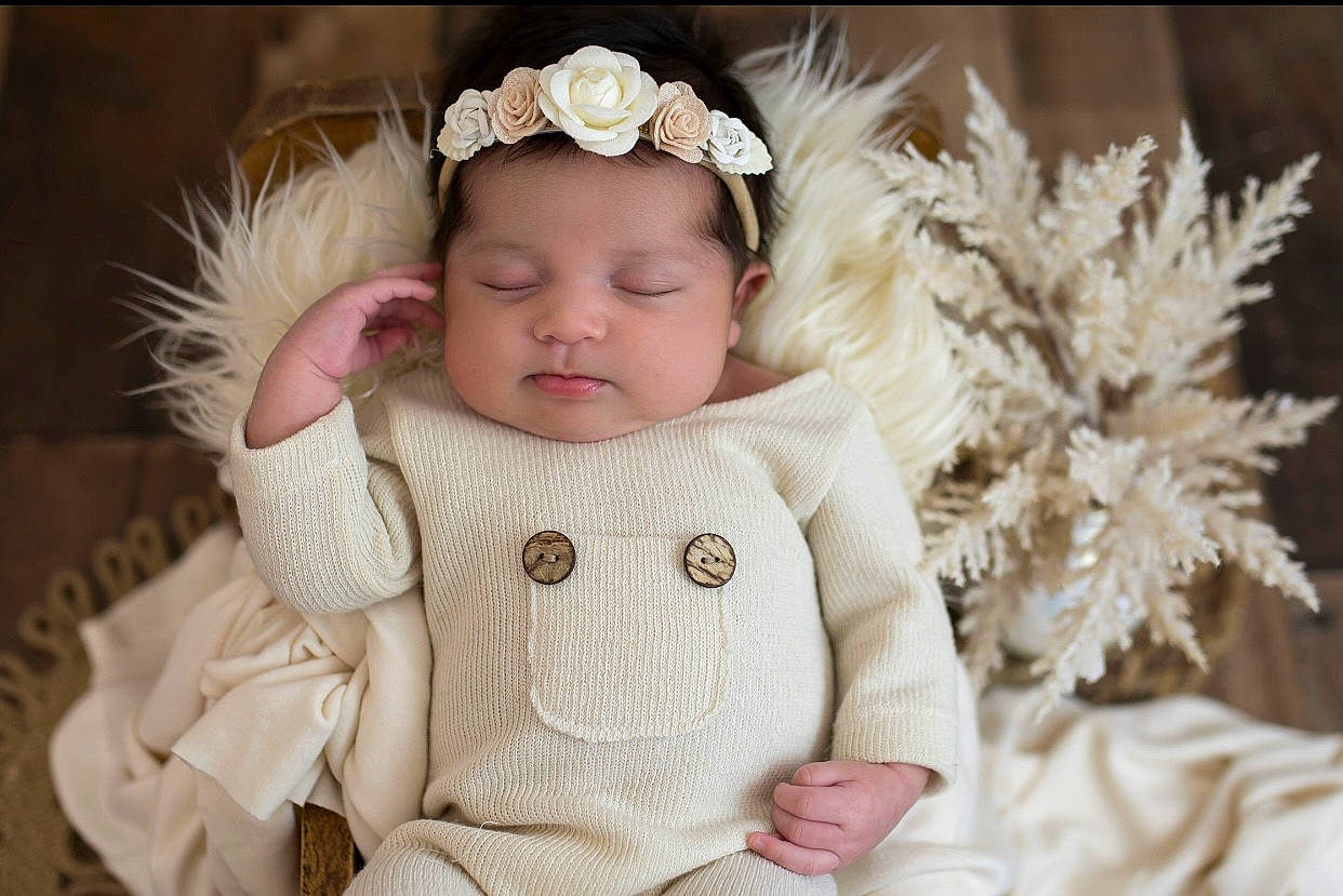 Melanie is registered to the contest to win money with this photo: baby, baby_toddler_clothing, cap, child, embellishment, fashion_accessory, flower, fur, fur_clothing, hand, happy, headband, headpiece, jewellery, lip, person, pink, skin, sleeve, textile
