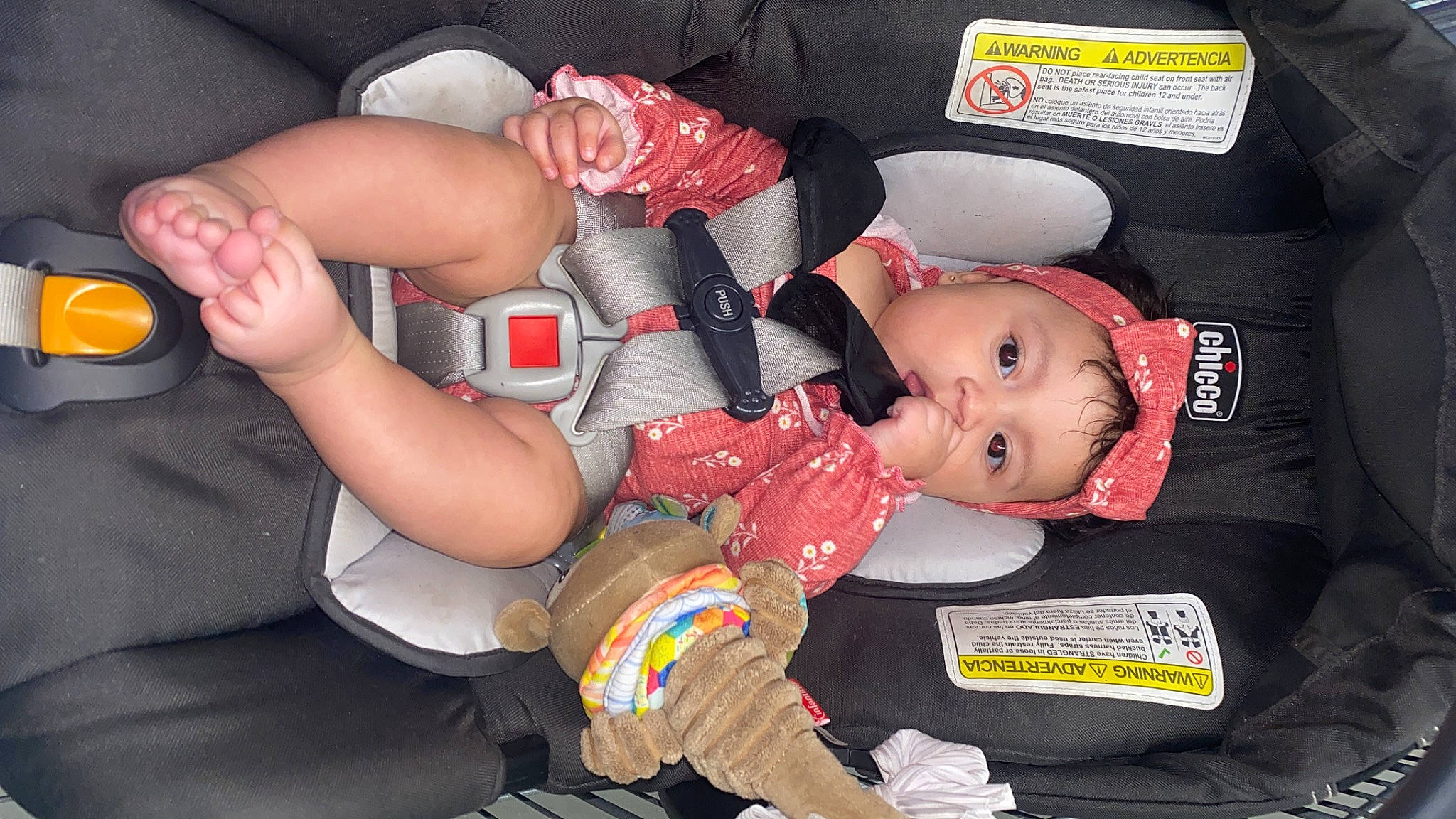 Melanie is registered to the contest to win money with this photo: baby, baby_carriage, baby_products, baby_toddler_clothing, carmine, child, comfort, elbow, fashion_accessory, fun, hat, human_leg, lap, mouth, nail, person, sitting, thigh, thumb, toddler