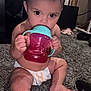 Azrahbella joined the competition — help win amazing prizes! baby, child, diaper, sippy_cup, carpet, indoor, curious, sitting, toy, household, floor, footwear, bracelet, person, infant, cute, young, holding, looking, home