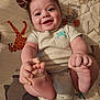 Lazarus is registered to the contest to win money with this photo: animal_print, baby, blanket, child, clothing, cute, face, feet, hands, happy, head, indoors, infant, onesie, person, playful, portrait, skin, smiling, young