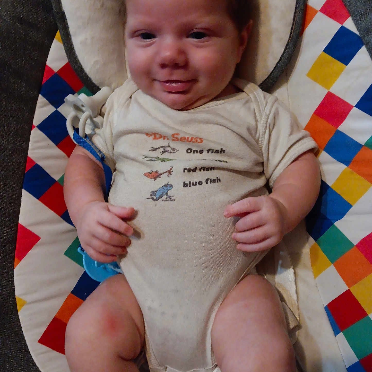 Bobby Joe is registered to the contest to win money with this photo: baby, bodypart, clothing, couch, cushion, face, finger, furniture, hand, happy, head, homedecor, newborn, person, photography, portrait, shorts, sitting, smile, t_shirt