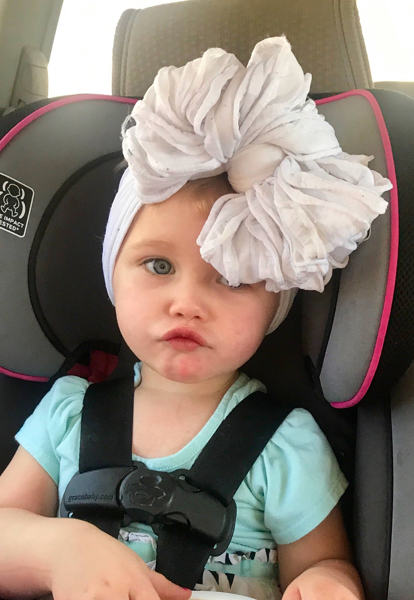 Renesmee is registered to the contest to win money with this photo: auto_part, baby, baby_carriage, baby_products, car_seat, child, fashion_accessory, hair_accessory, head, headgear, person, product, seat_belt, toddler