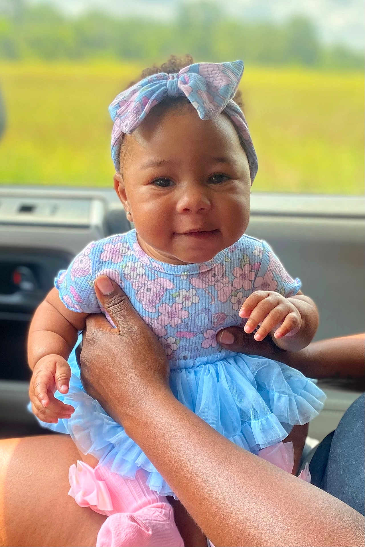 Yanni joined the competition — help win amazing prizes! baby, child, infant, headband, dress, floral, blue, pink, hand, adult, car_interior, window, nature_background, cute, smile, portrait, sitting, person, skin, toddler