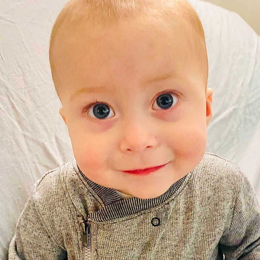 Oliver is registered to the contest to win money with this photo: baby, blonde, clothing, coat, cosmetics, crawling, face, hair, happy, head, knitwear, lipstick, person, photography, portrait, sleeve, smile, sweater