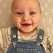 Joshua is registered to the contest to win money with this photo: baby, babylaughing, clothing, coat, face, happy, head, jeans, pants, person, photography, portrait, smile