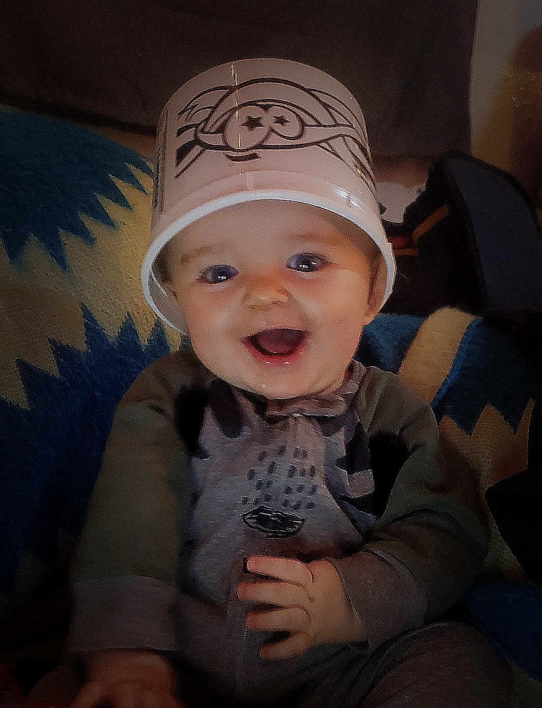 Rolland joined the competition — help win amazing prizes! baby, child, smiling, bucket, headwear, indoor, blanket, pattern, happy, cute, playful, clothing, sitting, infant, face, portrait, hand, fun, young, cozy