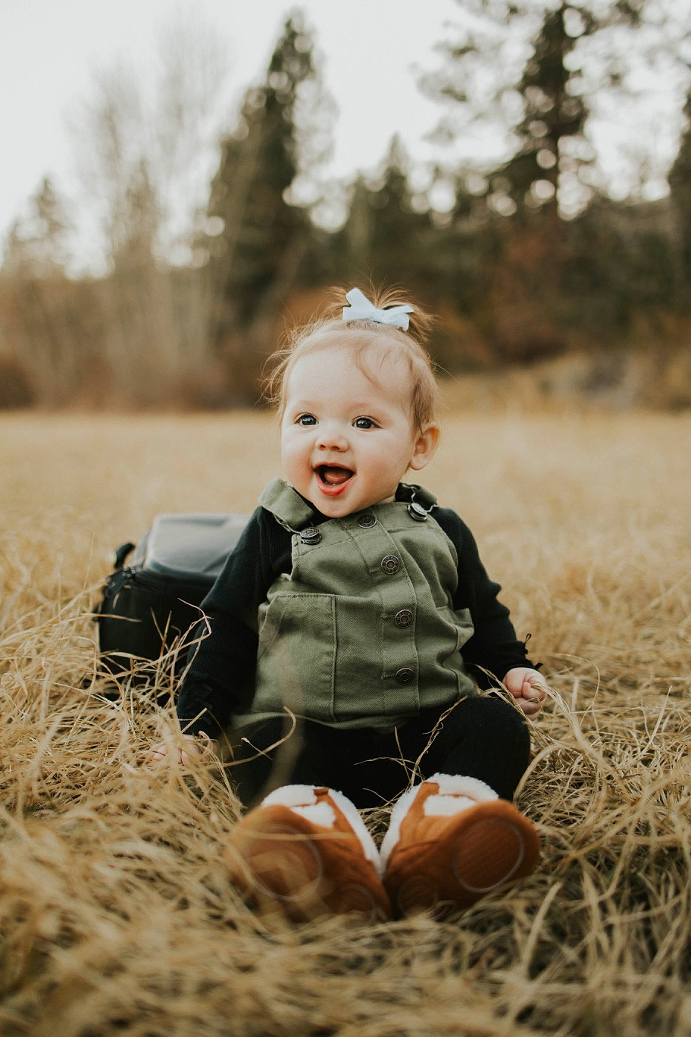 Mylah is registered to the contest to win money with this photo: baby_toddler_clothing, child, face, facial_expression, flash_photography, grass, grassland, happy, mammal, outerwear, people, people_in_nature, person, plant, sky, smile, standing, sunlight, toddler, tree