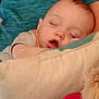 Mason is registered to the contest to win money with this photo: baby, sleeping, pillow, blue_shirt, child, resting, face, mouth_open, peaceful, indoors, soft_texture, comfort, closeup, young_child, nap, person, relaxing, cozy, candid, head