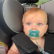 Daxson joined the competition — help win amazing prizes! baby, infant, child, car_seat, pacifier, blanket, portrait, face, blue_eyes, red_hair, sitting, secured, vehicle, car_interior, headrest, safety_harness, cozy, close_up, indoors, photography
