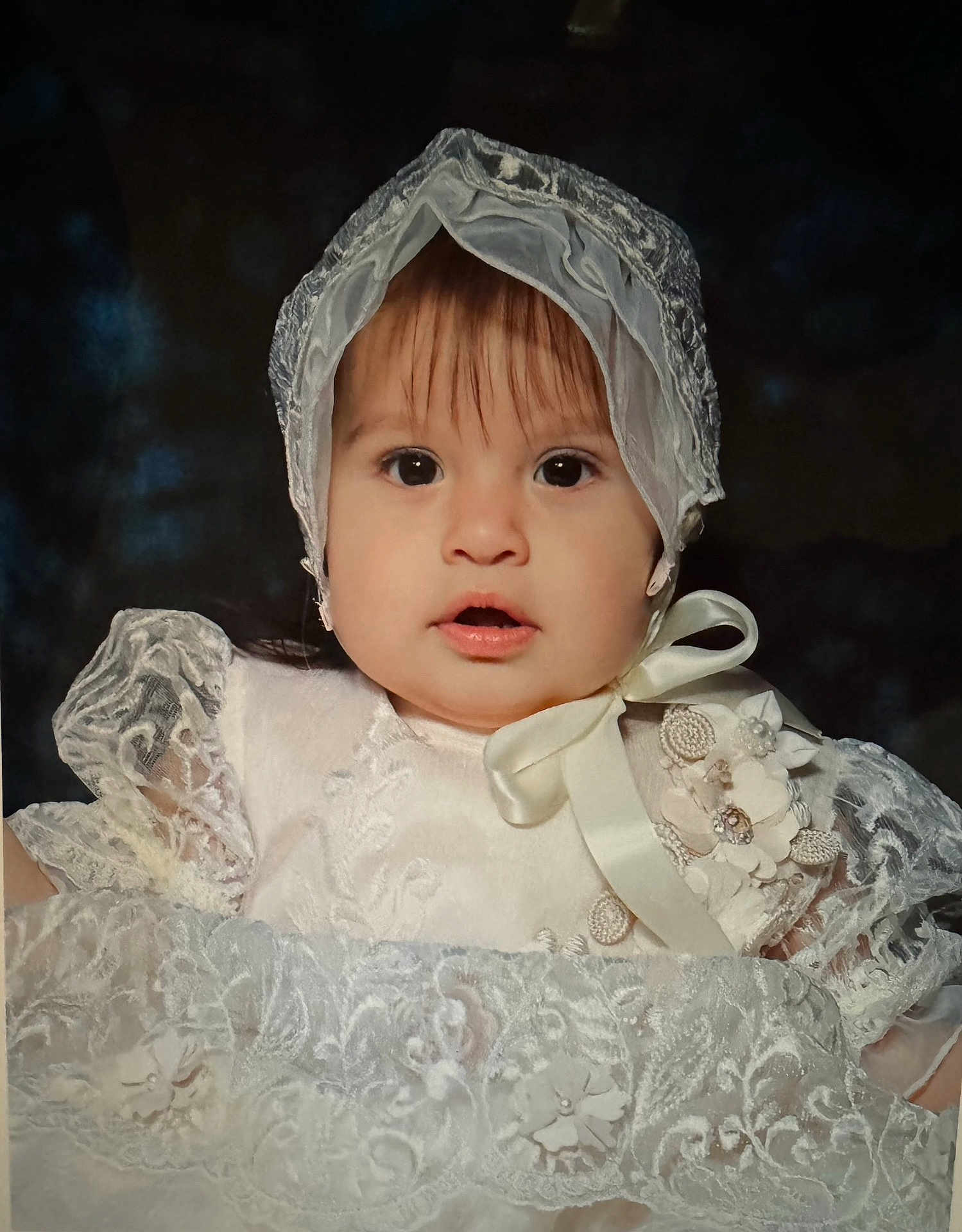 Mia joined the competition — help win amazing prizes! baby, child, face, portrait, white_dress, lace, bonnet, ribbon, flower, closeup, cute, young, infant, expression, soft_lighting, indoors, person, headwear, elegant, costume