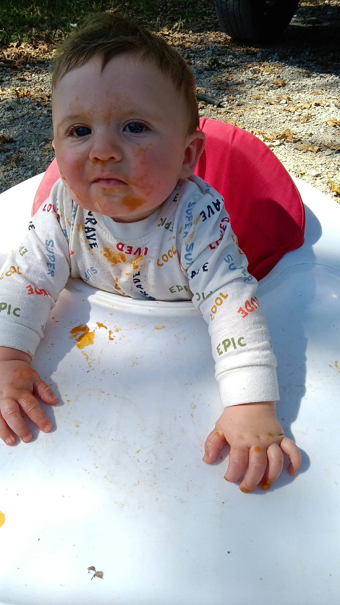 Karson is registered to the contest to win money with this photo: baby, baby_toddler_clothing, cheek, child, eye, face, flooring, fun, grass, happy, head, nose, pattern, people_in_nature, person, photograph, sitting, skin, sleeve, t_shirt