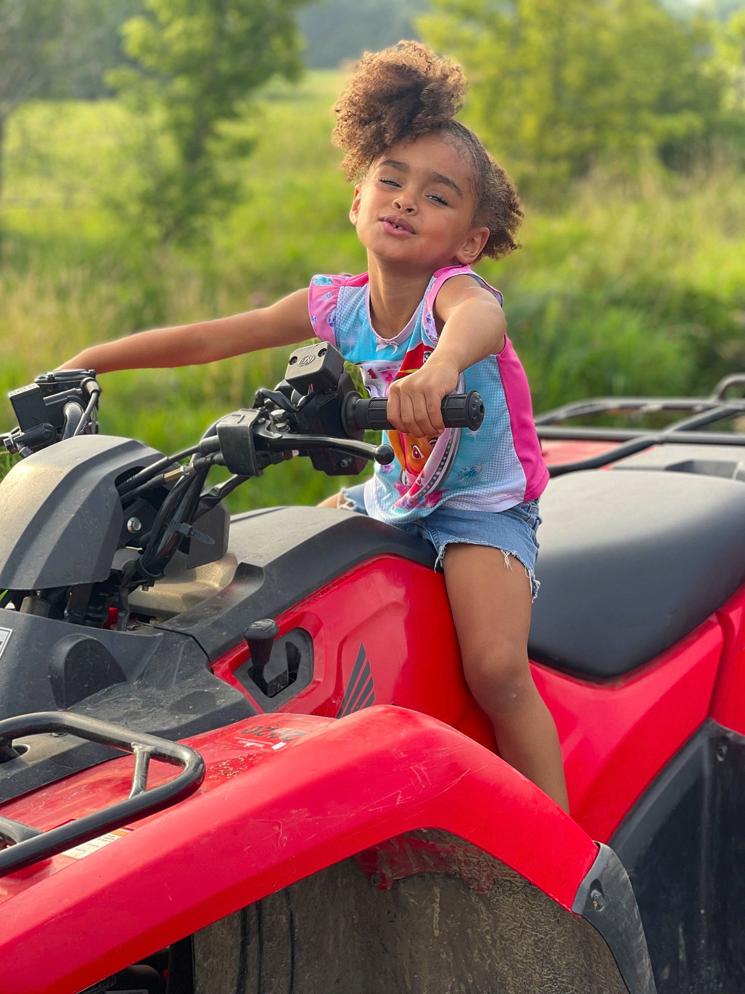 Alyse is registered to the contest to win money with this photo: auto_part, automotive_design, automotive_exterior, automotive_lighting, automotive_window_part, bumper, car, grass, happy, hood, joy, leisure, mode_of_transport, motor_vehicle, person, recreation, shorts, smile, tree, vehicle