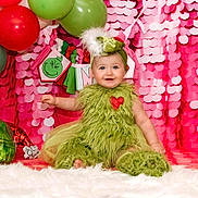 Brynlee joined the competition — help win amazing prizes! baby, balloon, clothing, costume, dress, elf, face, festival, fun, hair, hat, head, newborn, party, people, person, photography, portrait, sitting, toy