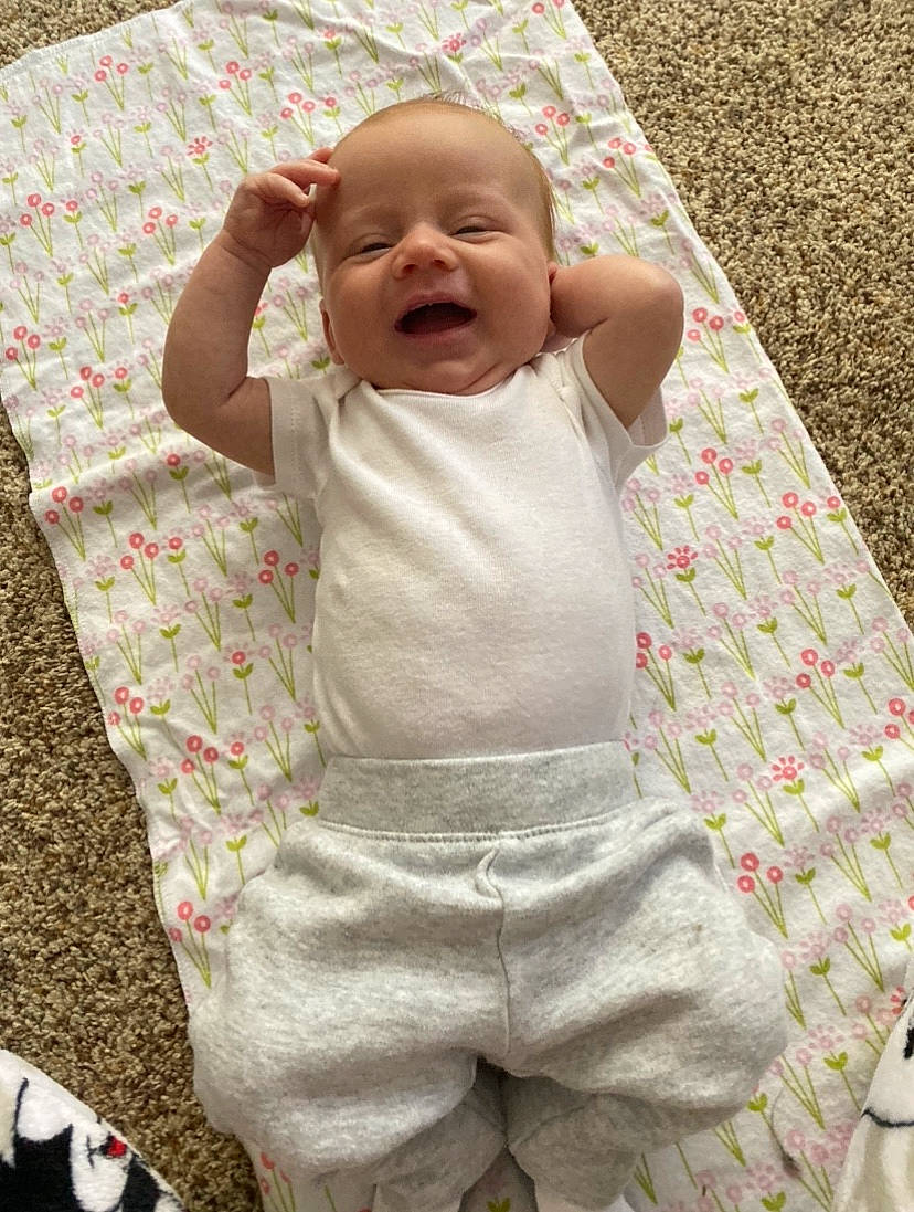 Rainbow is registered to the contest to win money with this photo: baby, baby_products, baby_toddler_clothing, cheek, child, facial_expression, linens, pattern, person, product, skin, sleep, smile, toddler