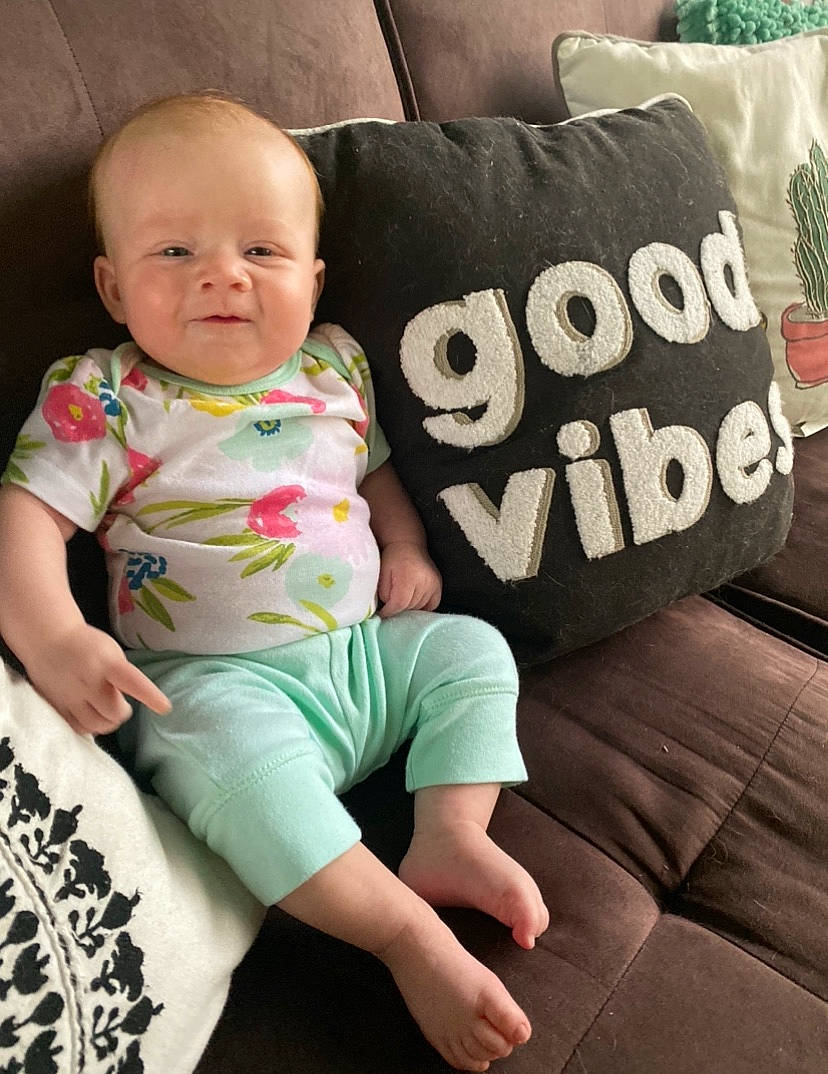 Rainbow is registered to the contest to win money with this photo: baby, baby_toddler_clothing, child, furniture, person, sitting, toddler