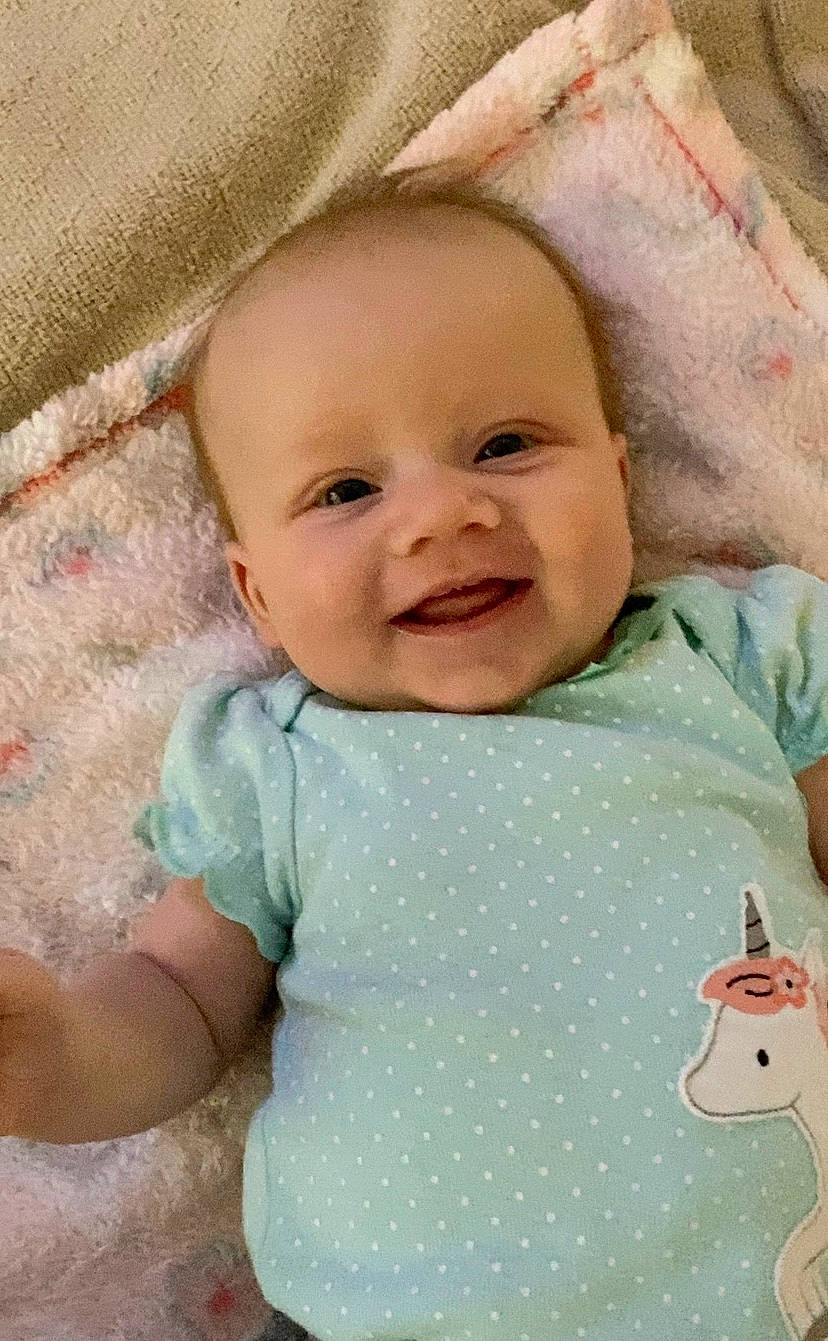 Rainbow joined the competition — help win amazing prizes! baby, baby_making_funny_faces, baby_products, baby_toddler_clothing, cheek, child, eye, face, facial_expression, head, lip, mouth, nose, person, pink, product, skin, smile, toddler