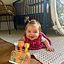 baby, carpet, child, clothing, colorful, crib, floor, furniture, girl, hair, happy, indoor, nursery, play, pony_tail, rug, smiling, toy, wooden_floor, wooden_toy