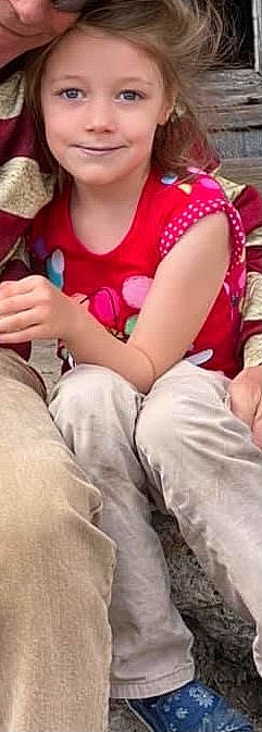 Evelyn is registered to the contest to win money with this photo: arm, comfort, elbow, event, eyewear, fun, gesture, happy, human_leg, joint, joy, knee, lap, leg, magenta, person, photograph, sitting, sleeve, t_shirt