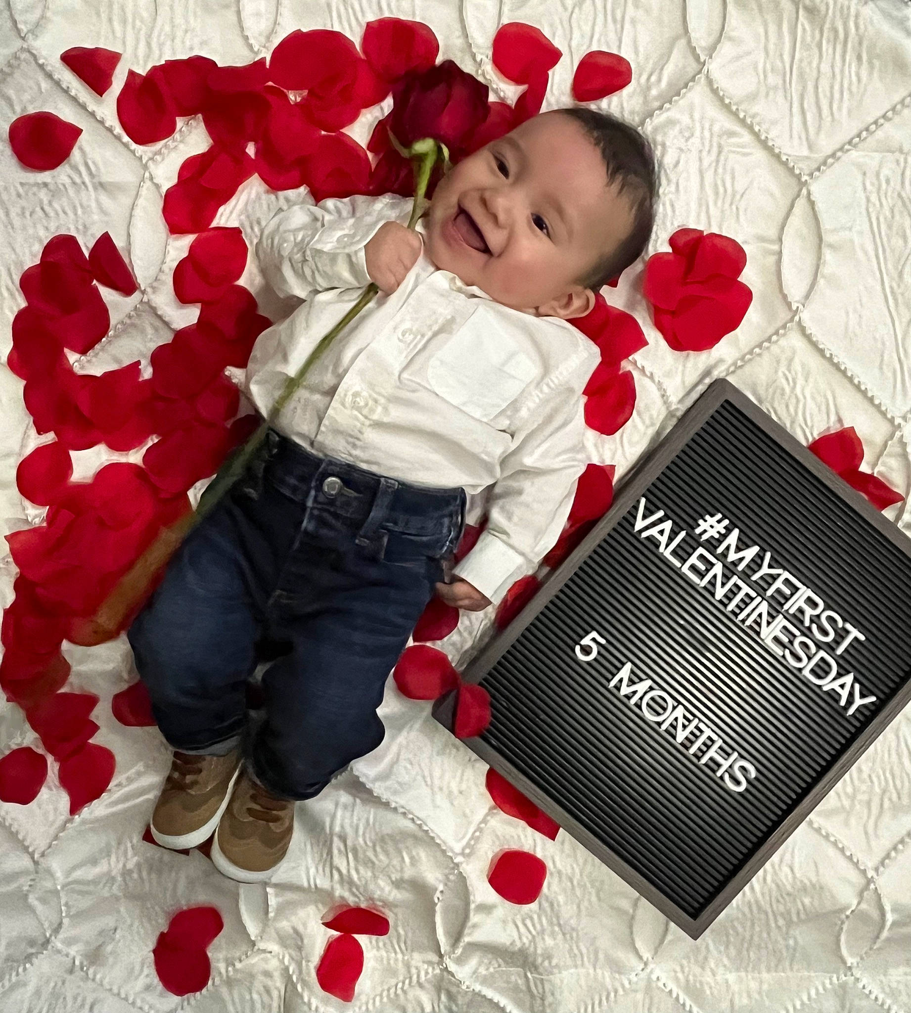 Jesus is registered to the contest to win money with this photo: baby, baby_toddler_clothing, beauty, carmine, child, christmas, facial_expression, flooring, font, happy, holiday, linens, pattern, person, petal, plant, red, sleeve, smile, textile