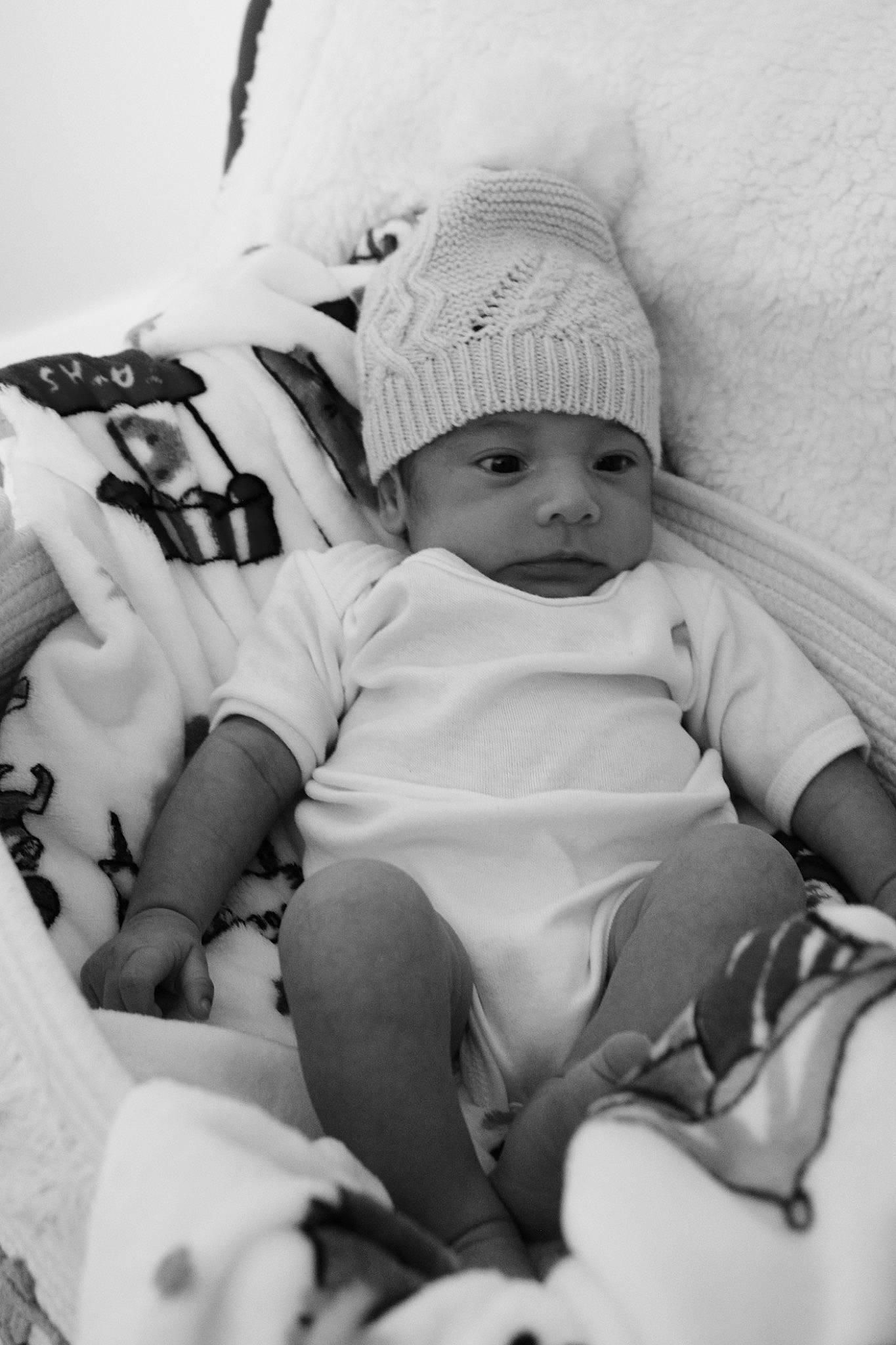 Mikah is registered to the contest to win money with this photo: baby, baby_products, baby_toddler_clothing, black, black_and_white, cap, child, comfort, flash_photography, happy, headgear, headwear, human_leg, monochrome, monochrome_photography, person, product, sitting, style, t_shirt