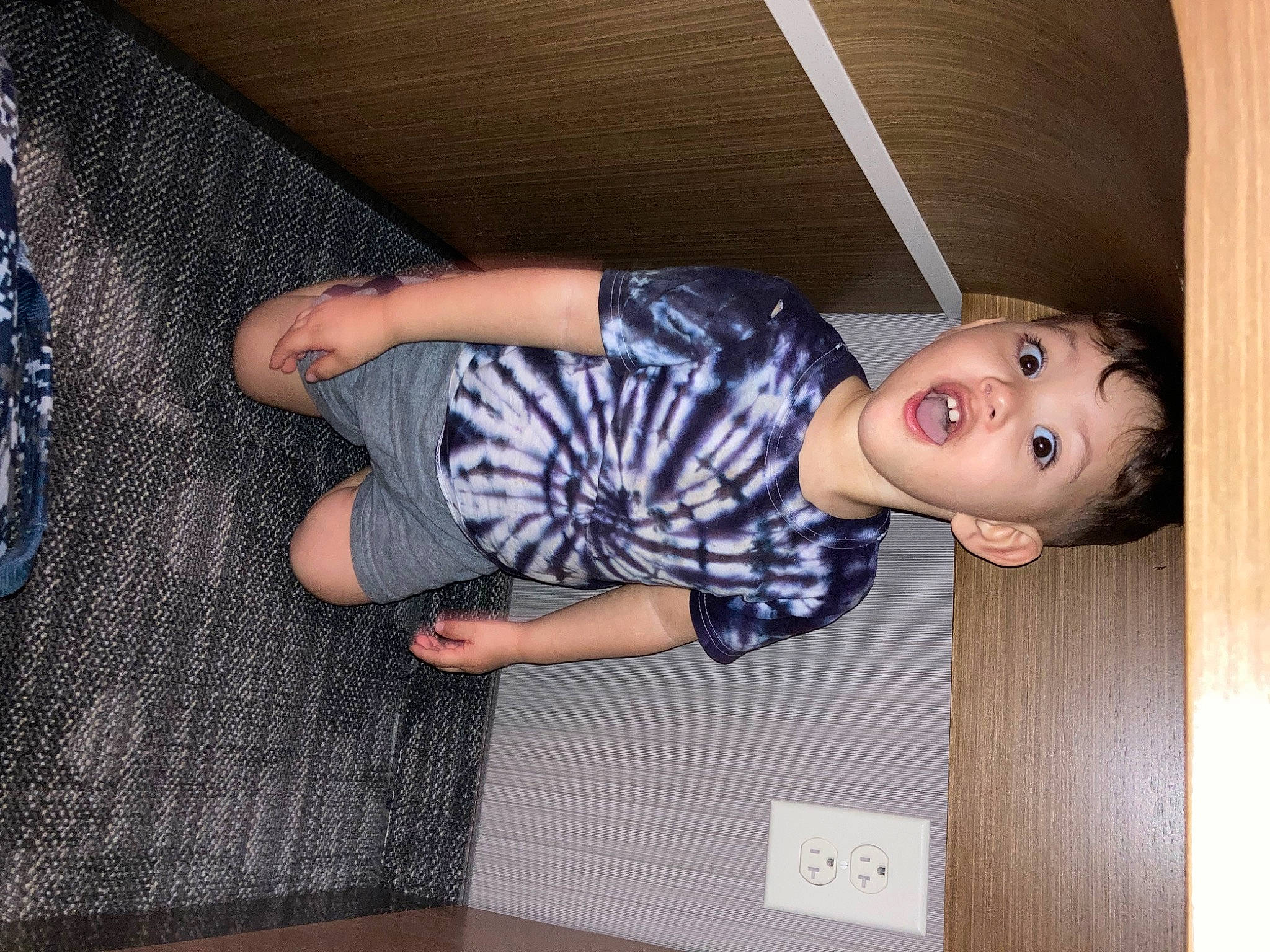 Keegan joined the competition — help win amazing prizes! child, comfort, denim, elbow, eyewear, finger, floor, flooring, fun, hardwood, human_leg, knee, pattern, person, plaid, room, sitting, sleeve, surprise, t_shirt