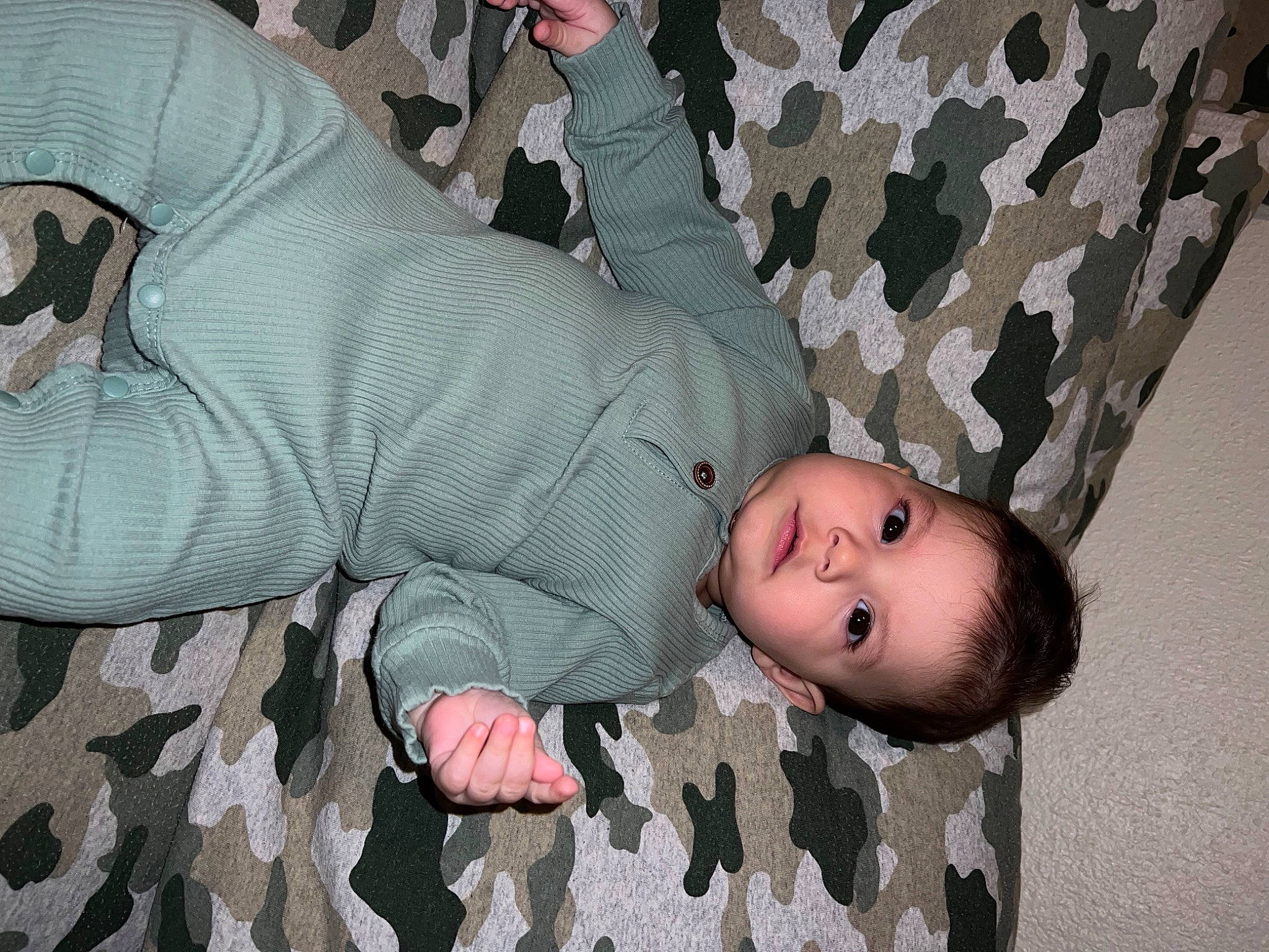 Malakai joined the competition — help win amazing prizes! arm, baby, baby_toddler_clothing, camouflage, cheek, child, comfort, facial_expression, gesture, head, human_body, joint, linens, mammal, military_camouflage, pattern, person, sleeve, toddler, tree