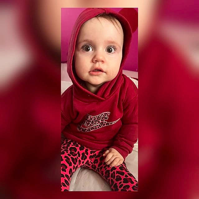 Angel is registered to the contest to win money with this photo: baby, baby_toddler_clothing, cheek, child, fashion_accessory, flash_photography, happy, human_leg, magenta, pattern, person, pink, portrait, portrait_photography, purple, sitting, sleeve, t_shirt, thigh, toddler
