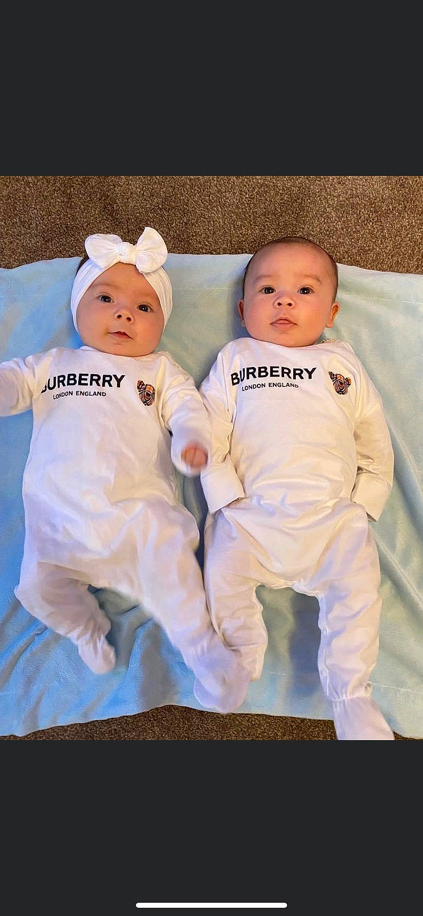 Lillie is registered to the contest to win money with this photo: baby, baby_toddler_clothing, child, comfort, event, eye, fun, gesture, happy, headwear, linens, orange, peach, person, photo_shoot, portrait_photography, sitting, sleeve, smile, t_shirt