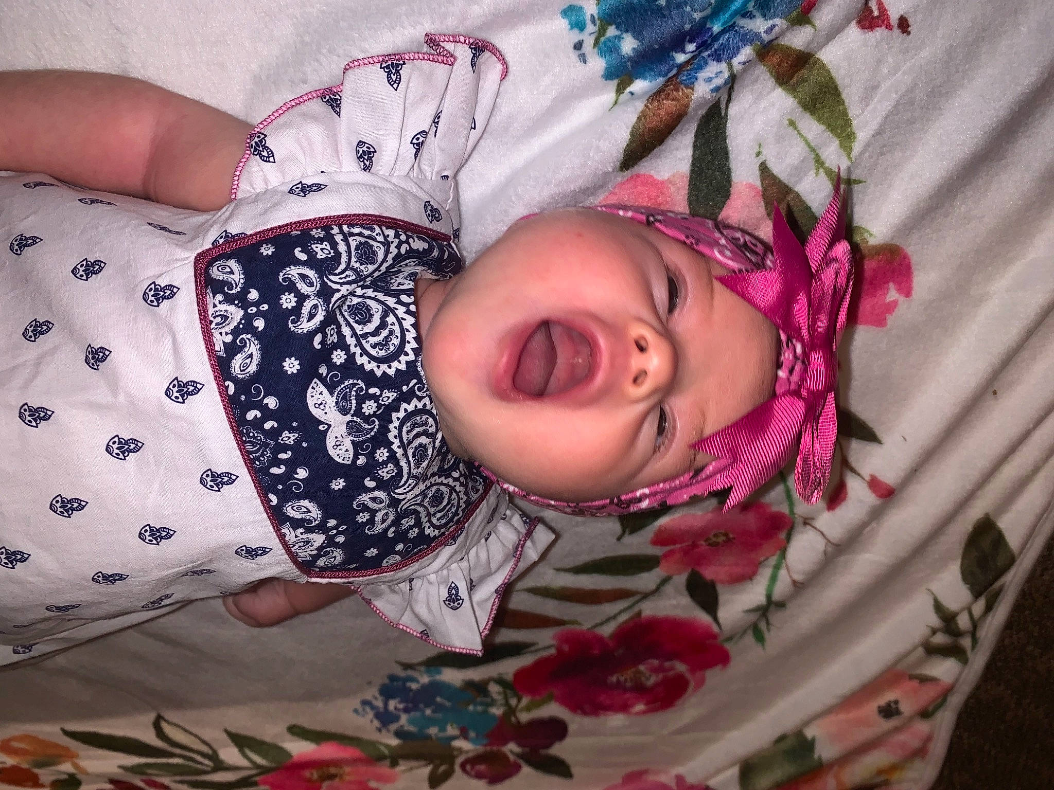 Avianna is registered to the contest to win money with this photo: baby, baby_toddler_clothing, cheek, child, eye, eyelash, face, fashion, head, headwear, human_body, leaf, mammal, pattern, person, pink, purple, skin, sleeve, smile