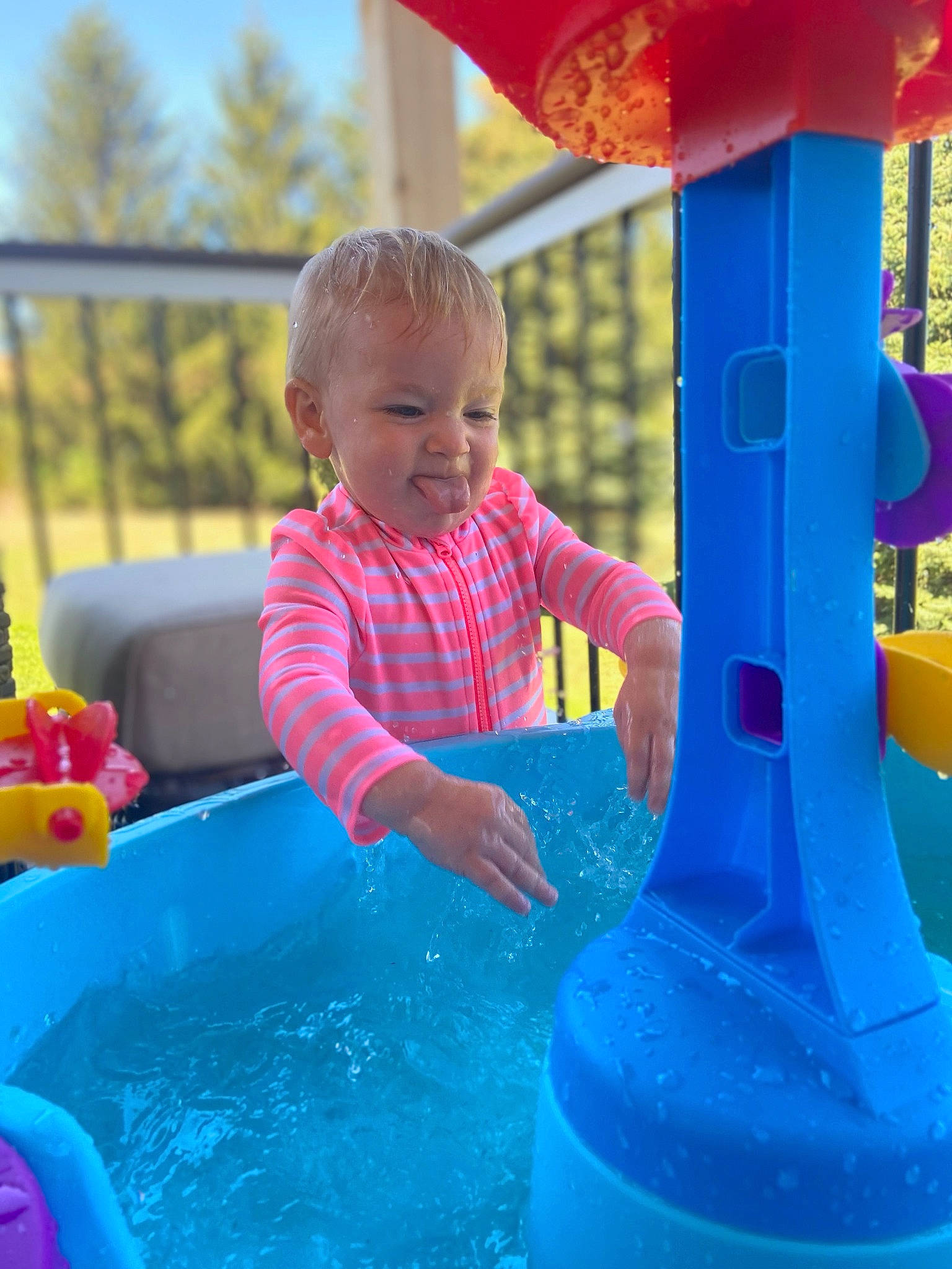Felicity is registered to the contest to win money with this photo: baby, baby_toddler_clothing, blue, child, chute, electric_blue, facial_expression, fun, games, happy, leisure, outdoor_play_equipment, person, play, playground, recreation, red, smile, toddler, water