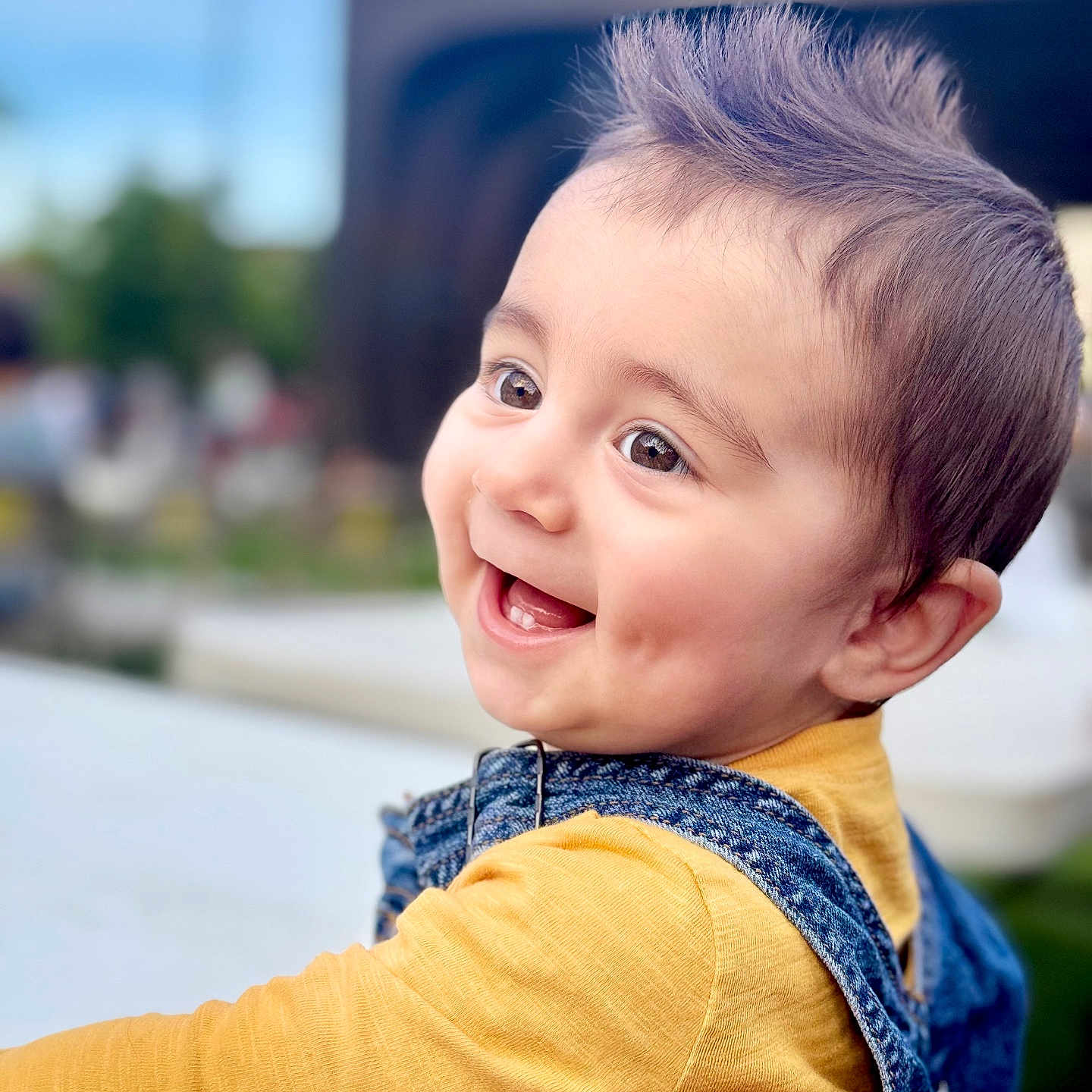 Noyan Muradzay is registered to the contest to win money with this photo: baby, blurry_background, child, cute, denim_overalls, expression, face, fashion, hairstyle, happy, holding, joy, outdoor, person, portrait, skin, smiling, toddler, yellow_shirt, youth