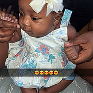 Divinity is registered to the contest to win money with this photo: baby, child, infant, headband, bow, dress, floral, hands, skin, cute, expression, person, feet, sitting, blanket, pattern, indoors, portrait, young_child, holding