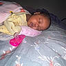 Divinity joined the competition — help win amazing prizes! baby, sleeping, blanket, pacifier, bed, pillow, infant, child, floral_bedspread, soft_lighting, peaceful, indoors, cute, resting, person, toddler, yellow_clothing, pink, face, calm